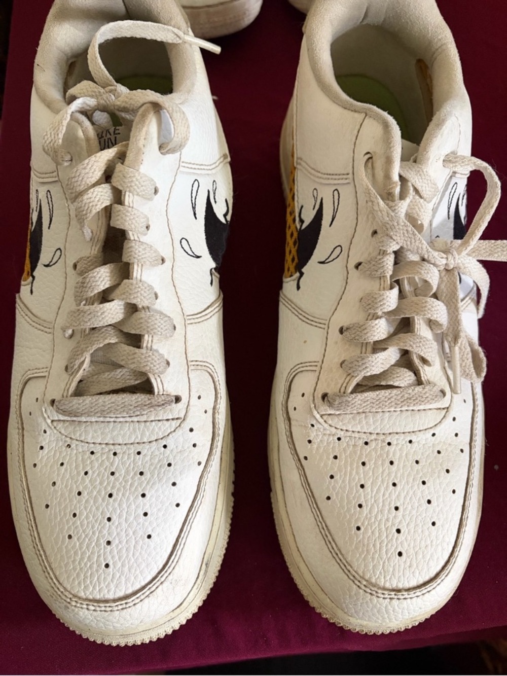 Nike Men’s White Leather Low-Top Sneakers with Black and Yellow Accents